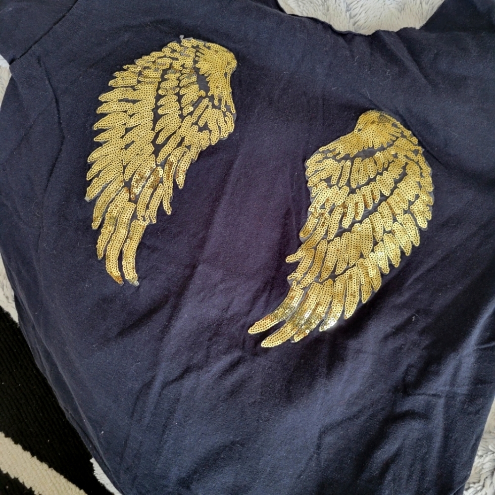 Off the shoulder sequin wings tee.